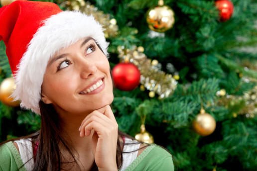 Pensive Christmas woman portrait with a Santa hat